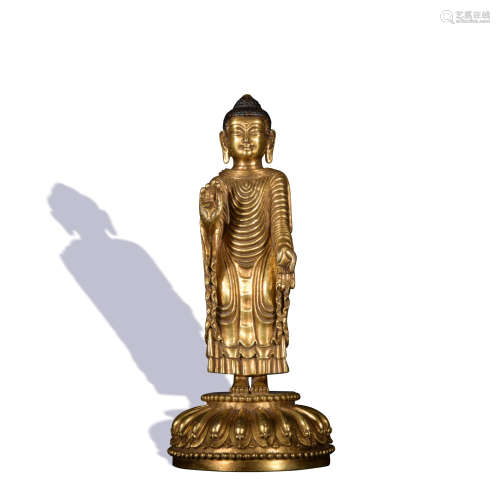 A gilt-bronze statue of standing buddha
