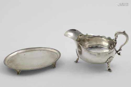 A GEORGE III OVAL TEA POT STAND on bracket feet with bead bo...