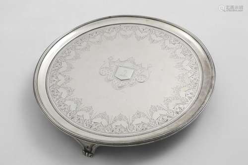 A GEORGE III CIRCULAR SALVER with a reeded border, bright-en...