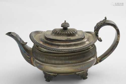 A GEORGE IV BELLIED TEA POT of rounded oblong form with a ri...