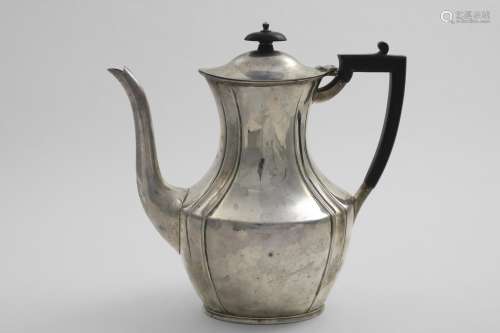 AN EDWARDIAN COFFEE POT with a waisted upper body and an ang...