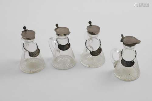 A MATCHED SET OF FOUR GEORGE V MOUNTED GLASS WHISKEY TOTS OR...