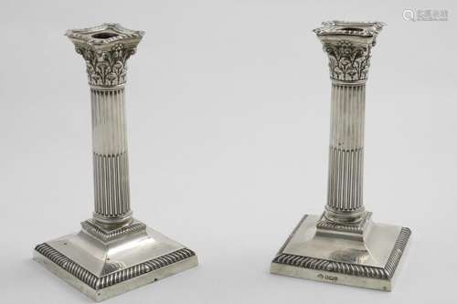 A PAIR OF EDWARDIAN / GEORGE V CANDLESTICKS with fluted colu...