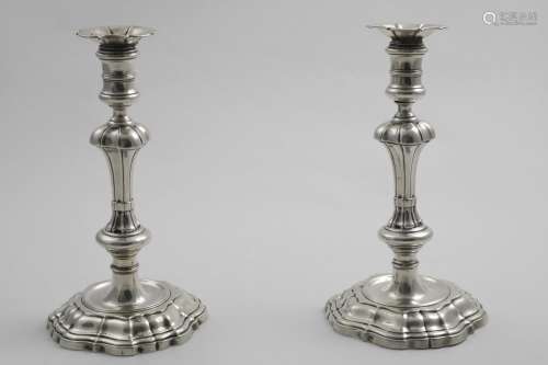 A PAIR OF GEORGE II CAST CANDLESTICKS on shaped and domed ba...