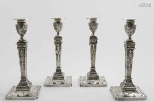 A SET OF FOUR ELIZABETH II CANDLESTICKS in the neo-classical...