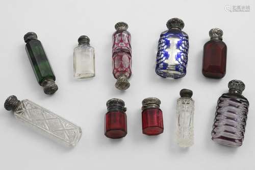 VICTORIAN-MOUNTED CUT-GLASS SCENT BOTTLES:- Three clear glas...