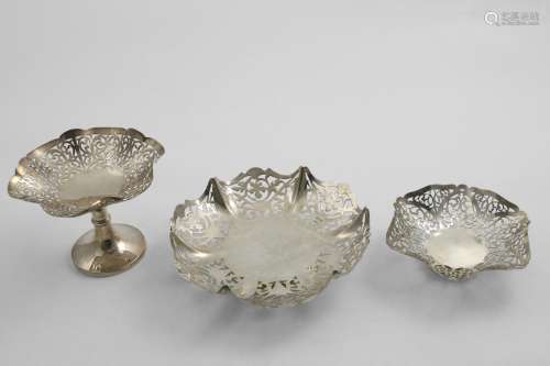 THREE SMALL PIERCED DISHES with shaped rims; the largest one...