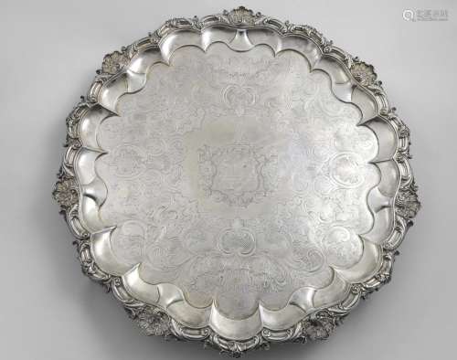 A WILLIAM IV LARGE SALVER of shaped circular outline with a ...
