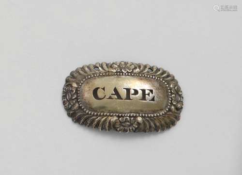 CAPE:- A George III oval wine label with a chased border of ...