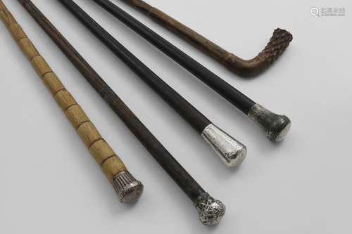 FOUR VARIOUS MOUNTED WALKING CANES and a wooden example with...