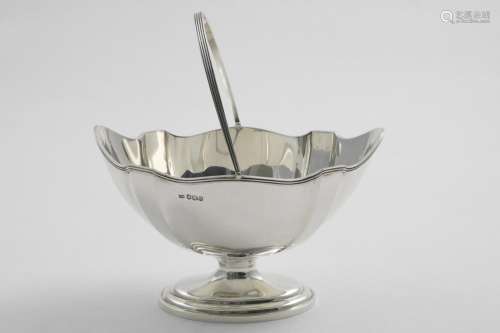 A GEORGE V SWING-HANDLED SUGAR BASKET with a boat-shaped bod...