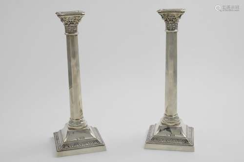 A PAIR OF GEORGE VI CANDLESTICKS on decorated square bases, ...