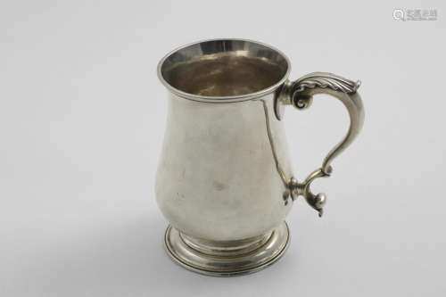 A GEORGE BALUSTER MUG with a spreading circular foot and a l...