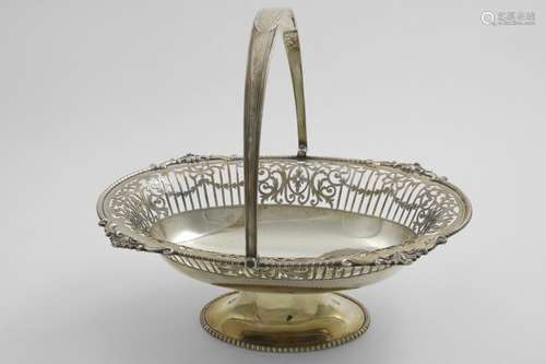 A GEORGE V SWING-HANDLED OVAL CAKE BASKET with decorative bo...