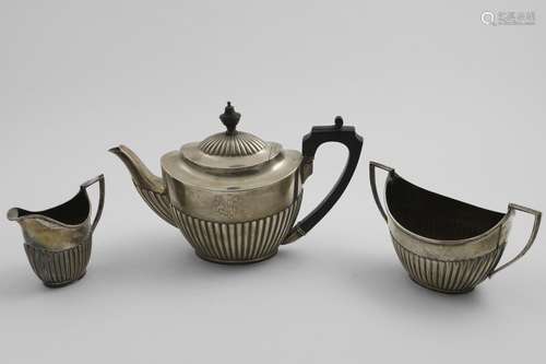 A LATE VICTORIAN THREE-PIECE TEA SET with angular handles an...