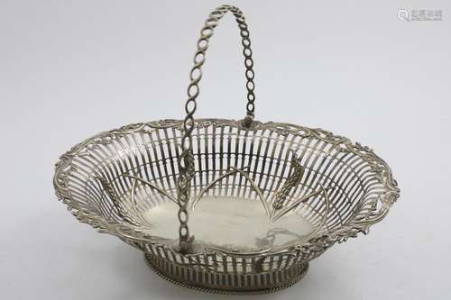 A GEORGE III IRISH SWING-HANDLED CAKE BASKET of shaped oval ...