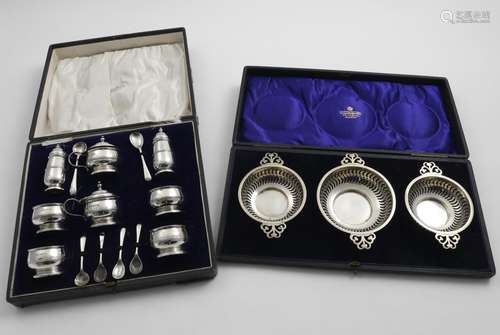 A GEORGE V CASED EIGHT-PIECE CONDIMENT SET with blue glass l...