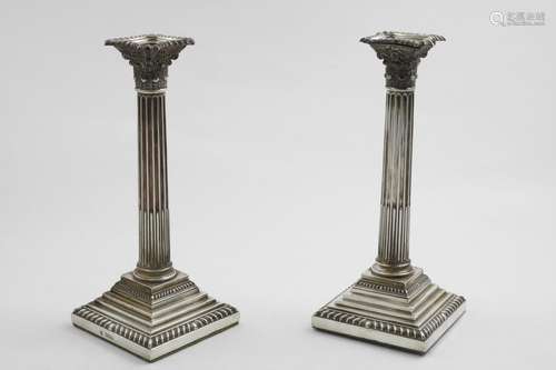 A PAIR OF LATE VICTORIAN CANDLESTICKS with fluted columns, C...