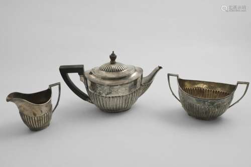 A LATE VICTORIAN THREE-PIECE TEA SET with part-fluted oval b...