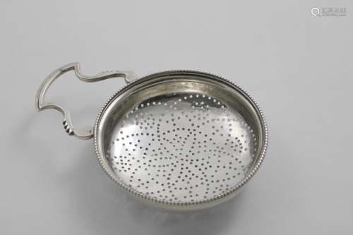A GEORGE III LEMON STRAINER with a bead border and a shaped ...