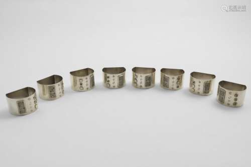 AN ELIZABETH II SET OF EIGHT NAPKIN RINGS with flat bases, e...