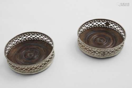 A PAIR OF GEORGE III WINE COASTERS with fret-pierced sides, ...