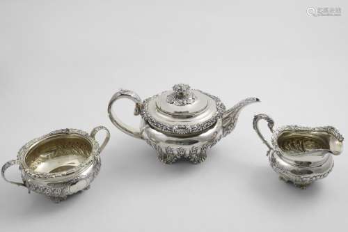 A GEORGE IV TEA POT with an embossed, squat circular body, o...