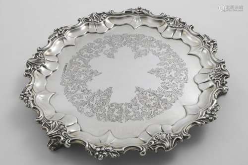 AN EDWARDIAN SALVER of shaped circular outline with a border...