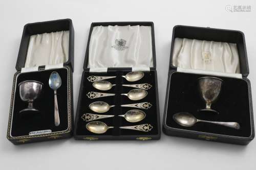 AN ELIZABETH II CASED EGG-CUP AND SPOON another similar, and...