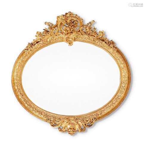 A LARGE ITALIAN CARVED GILTWOOD OVAL WALL MIRROR