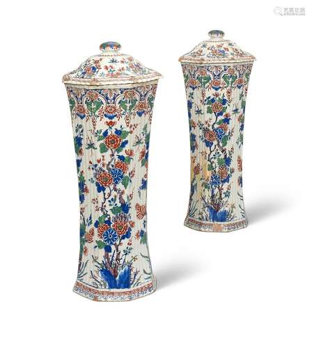 A PAIR OF DUTCH DELFT WAISTED RIBBED VASES AND COVERS