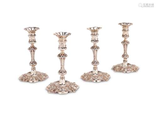 A SET OF FOUR GEORGE IV CAST SHAPED CIRCULAR CANDLESTICKS BY...