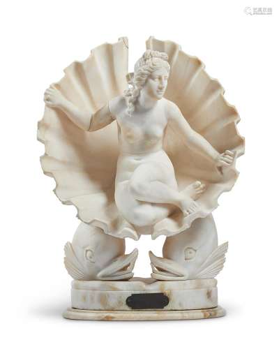 A CARVED ALABASTER GROUP OF VENUS IN A SHELL