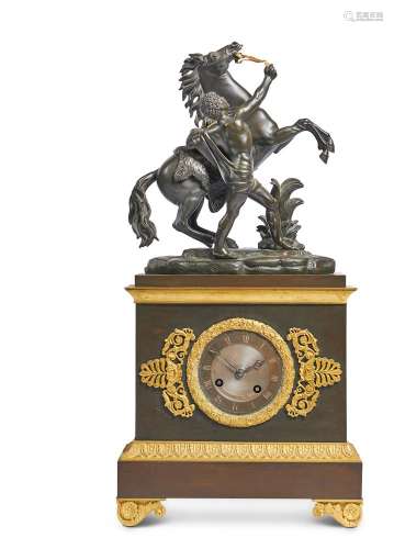 AN EMPIRE STYLE FRENCH BRONZE AND GILT METAL MANTEL CLOCK WI...