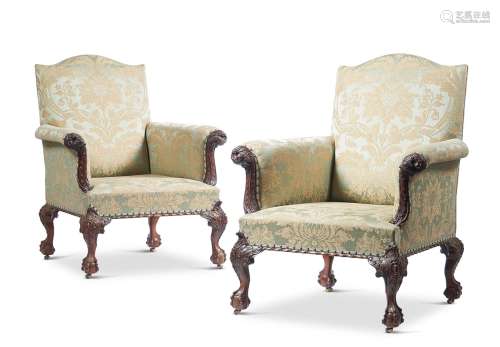 A PAIR OF GEORGE II STYLE CARVED MAHOGANY LIBRARY ARMCHAIRS