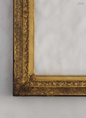 A PICTURE FRAME with leaf and scroll outer edge, stylised ac...