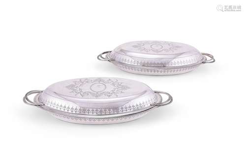 A pair of very large George III silver oval entree dishes an...