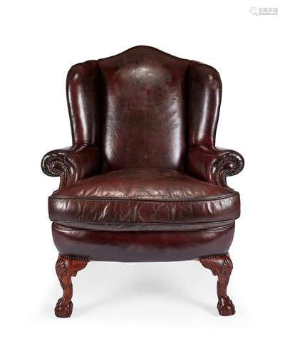 A George I style oak carved wing armchair