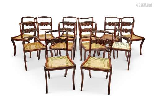 A set of twelve Regency mahogany carved dining chairs