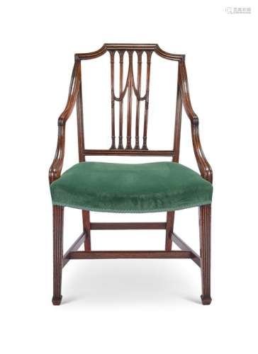 A George III carved mahogany open armchair attributed to Gil...