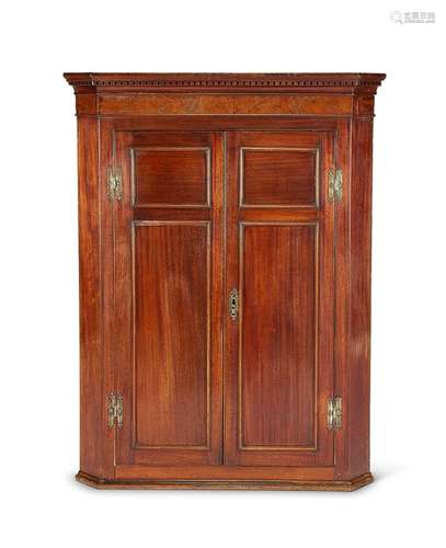 A George III mahogany corner cupboard