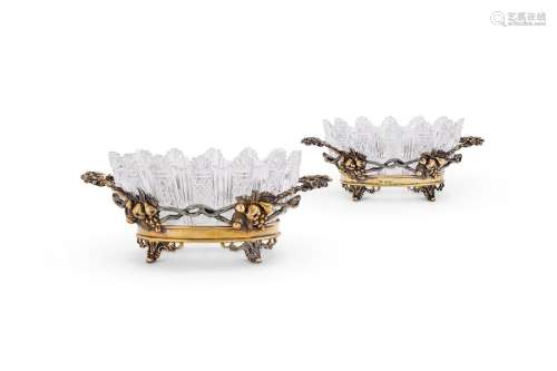 A good pair of Edwardian cast silver-gilt sweet dishes by Is...