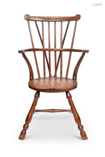 A George III walnut, beech and sycamore comb-back Windsor ch...