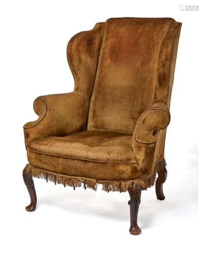 A late 19th century Queen Anne style carved walnut wing armc...
