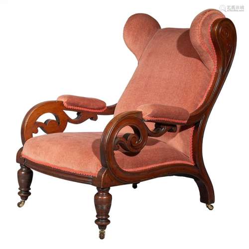 A Victorian carved mahogany wing back armchair