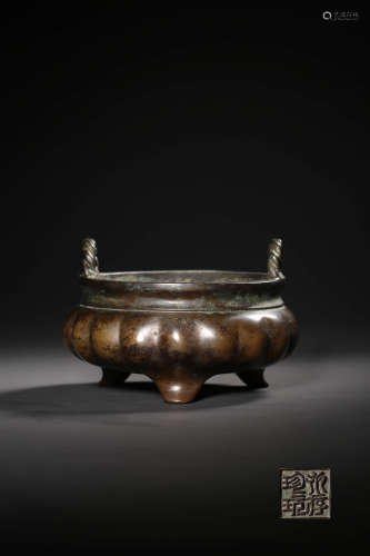 A BRONZE MELON-SHAPED DOUBLE-EARED TRIPOD INCENSE BURNER