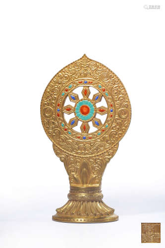 A GOLD-ENAMEL AND PAINTED BUDDHIST WHEEL ORNAMENT