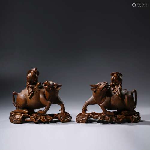 A Pair Of Wood Child And Buffalo Ornaments