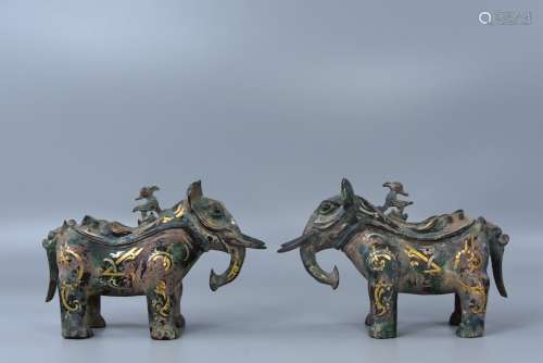 A pair of Chinese rubbed gold and silver elephants