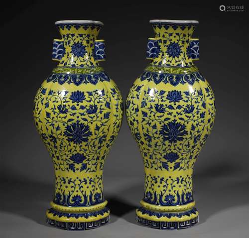 A PAIR OF QING DYNASTY YELLOW GROUND BLUE AND WHITE WALL VAS...